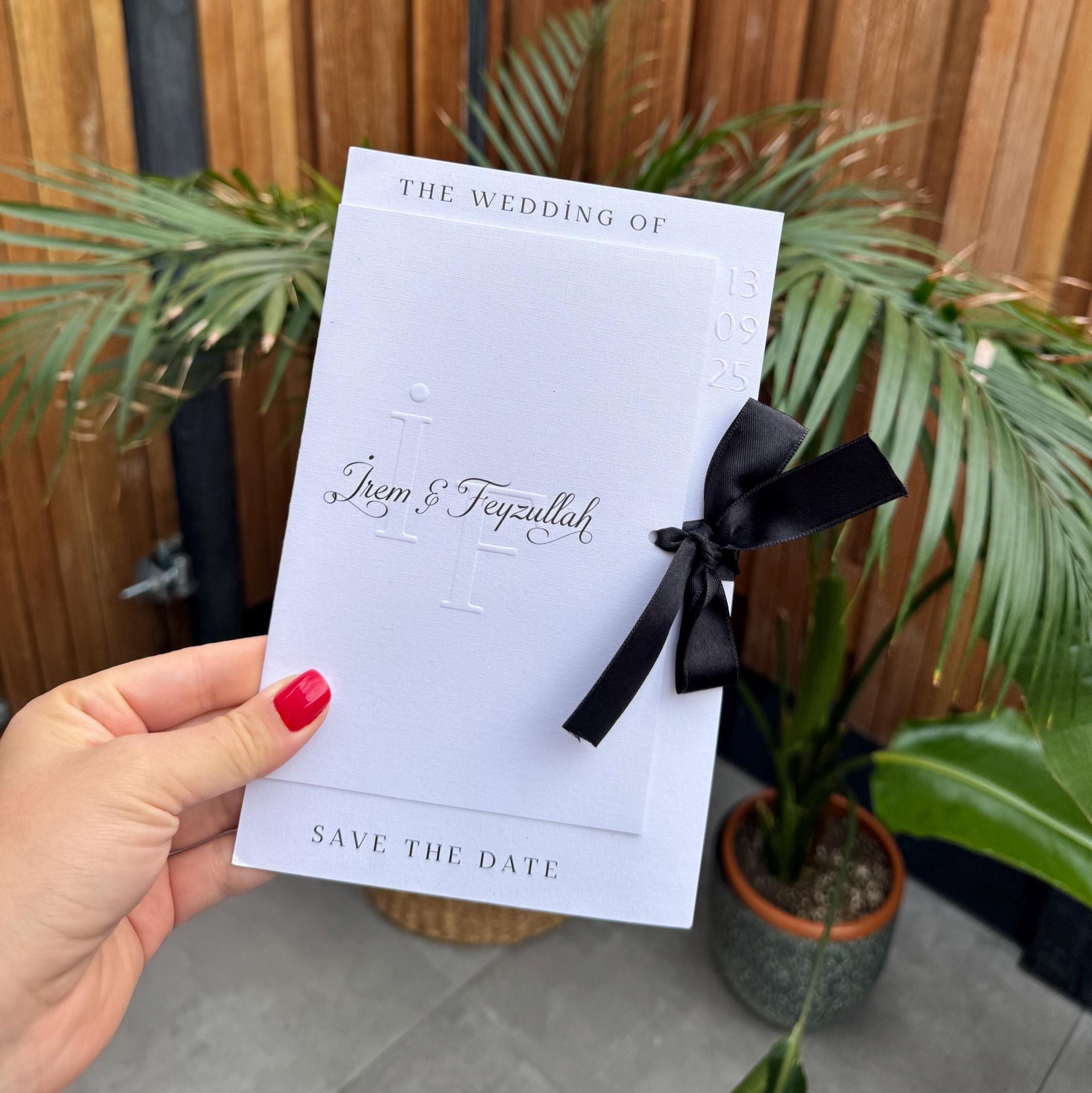 White Modern Wedding Invitation With Black Ribbon Embossed Text