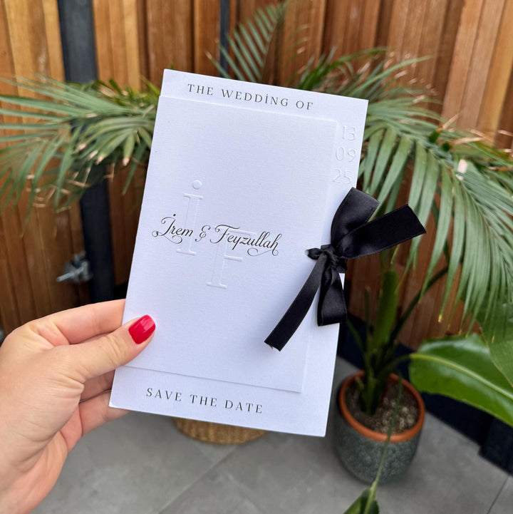White Modern Wedding Invitation With Black Ribbon Embossed Text