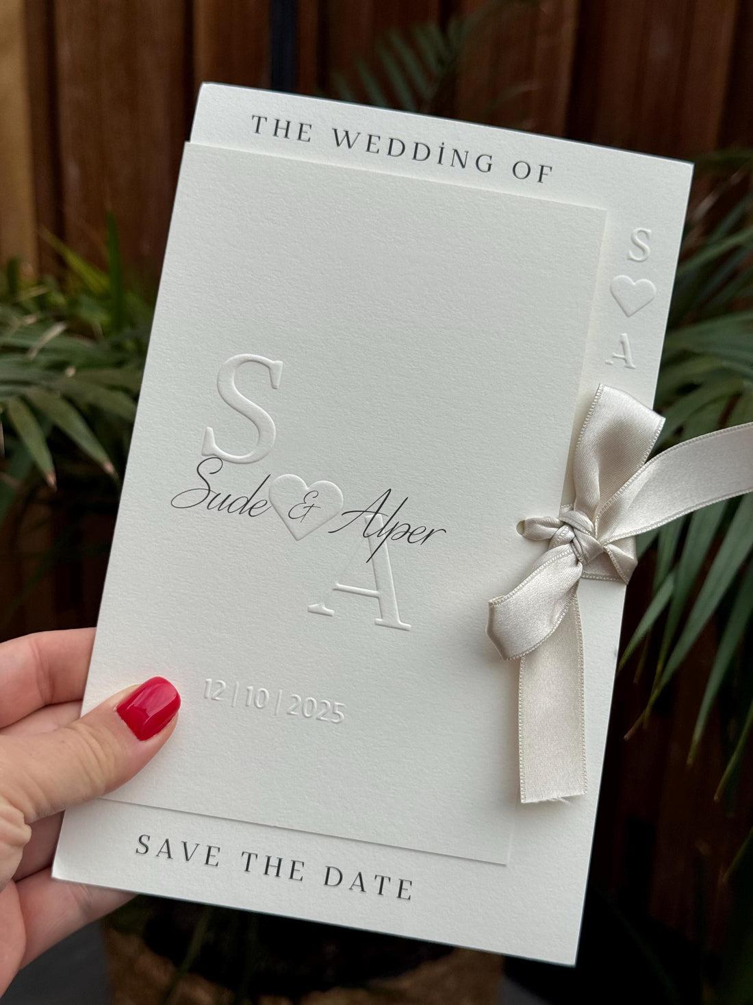 Cream Modern Wedding Invitation With White Ribbon Embossed Text