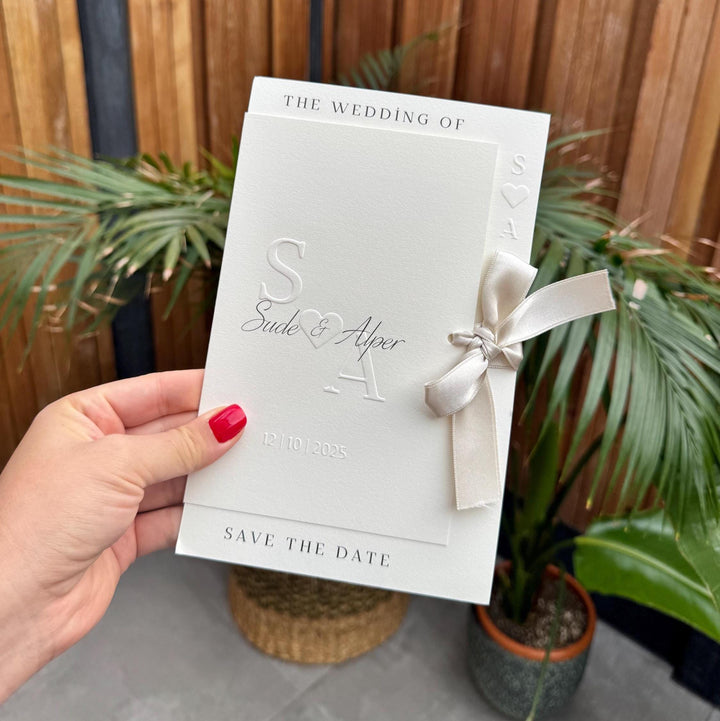Cream Modern Wedding Invitation With White Ribbon Embossed Text