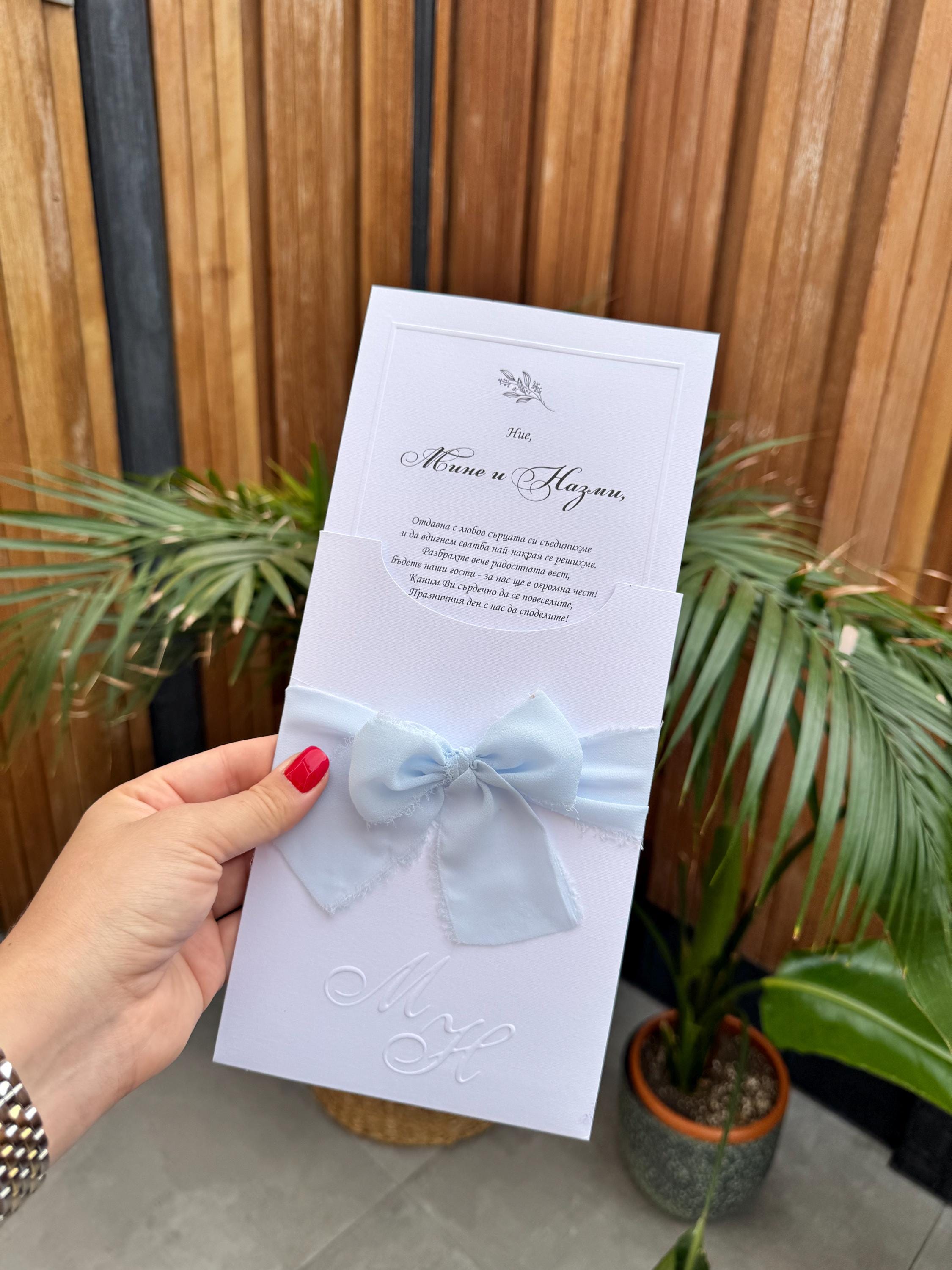 White Wedding Invitation With Blue Ribbon and Embossed Text