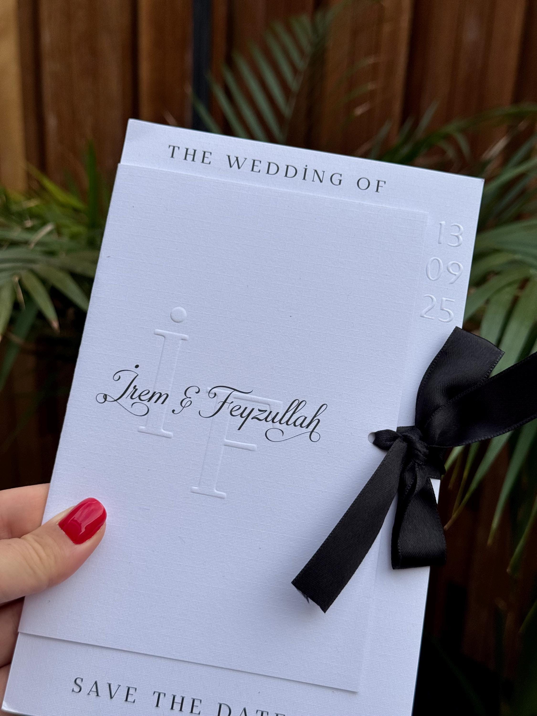 White Modern Wedding Invitation With Black Ribbon Embossed Text