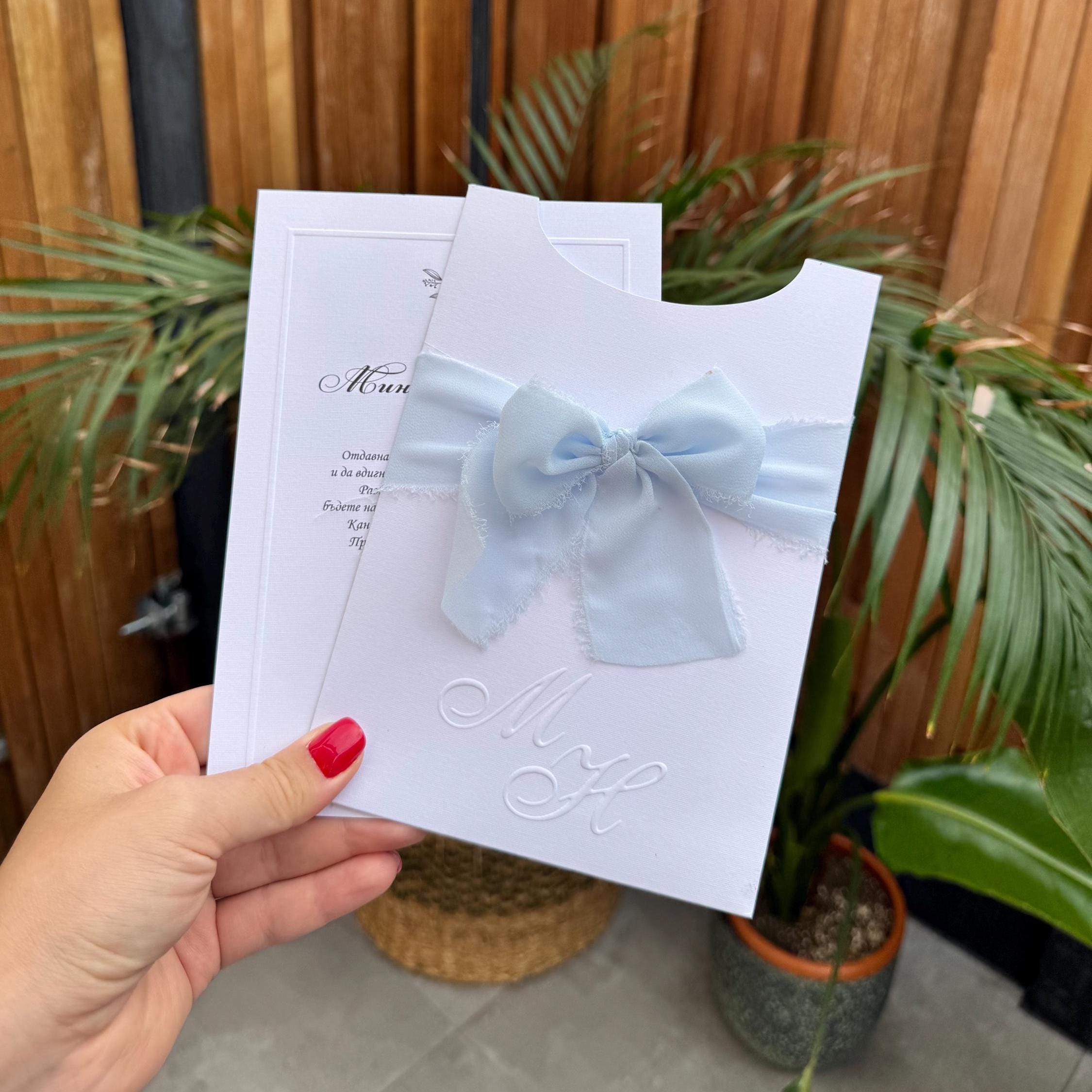 White Wedding Invitation With Blue Ribbon and Embossed Text