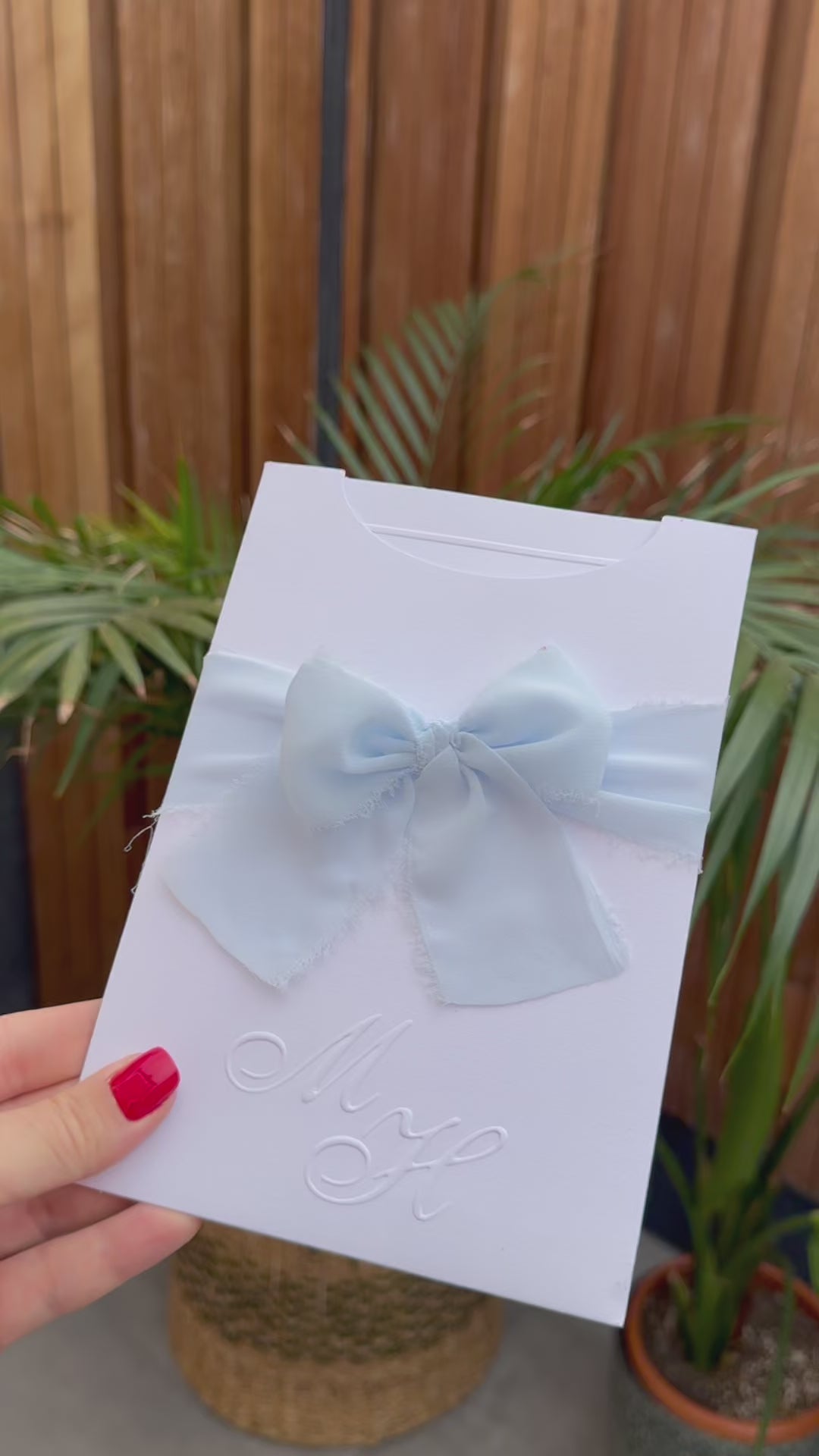 White Wedding Invitation With Blue Ribbon and Embossed Text
